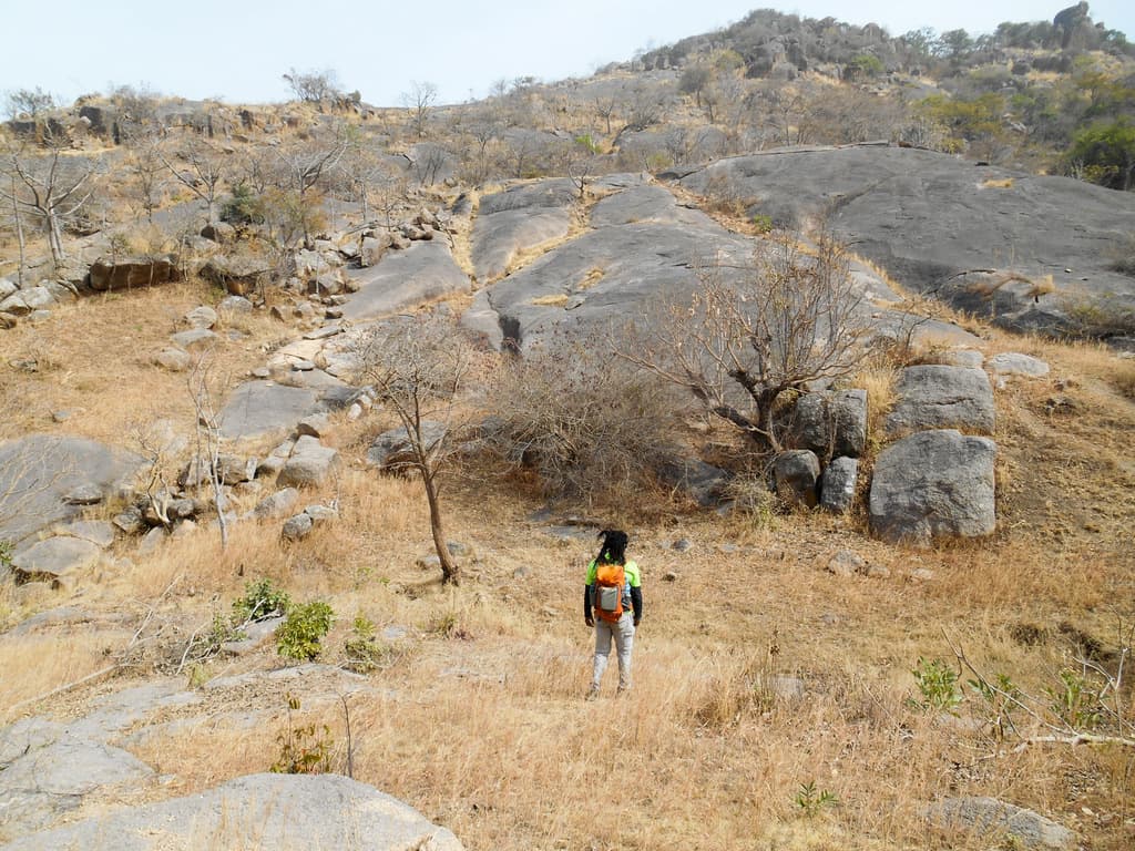 A man hikimg a section of Shere hills in Jos, Plateau state